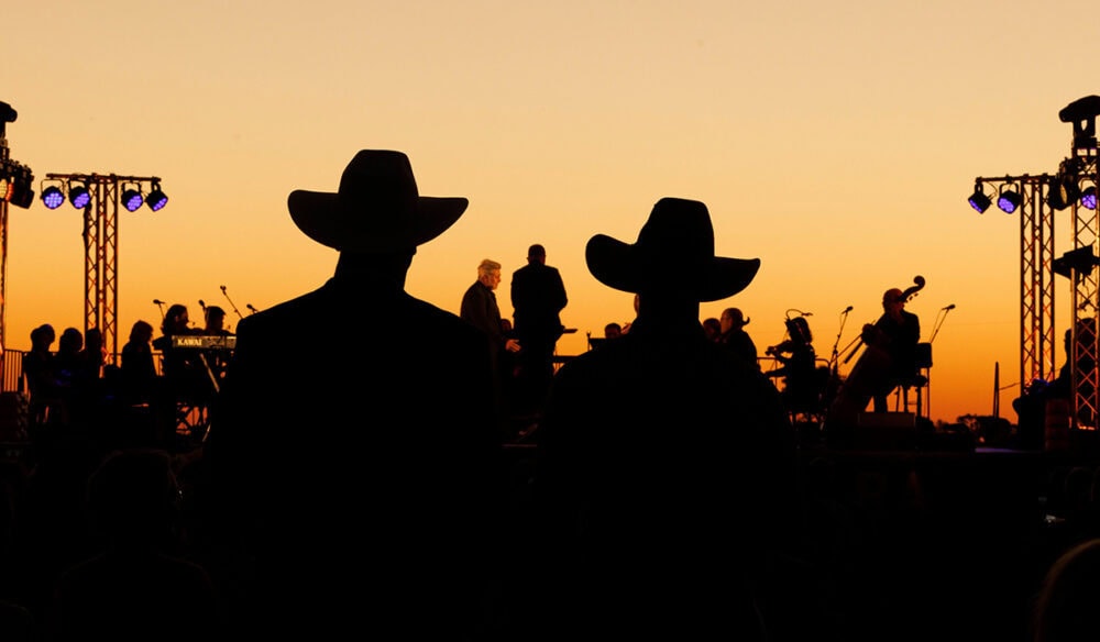 silouettes of crowd and performers at Festival of Outback Opera Singing In The Night event 2024