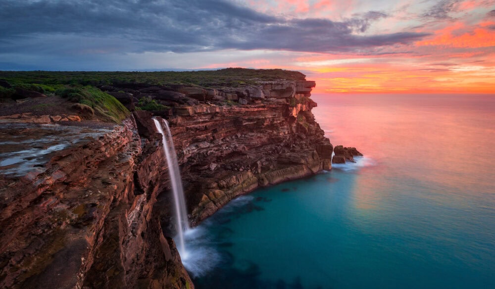 a scenic view of Curracurrong Falls at sunset