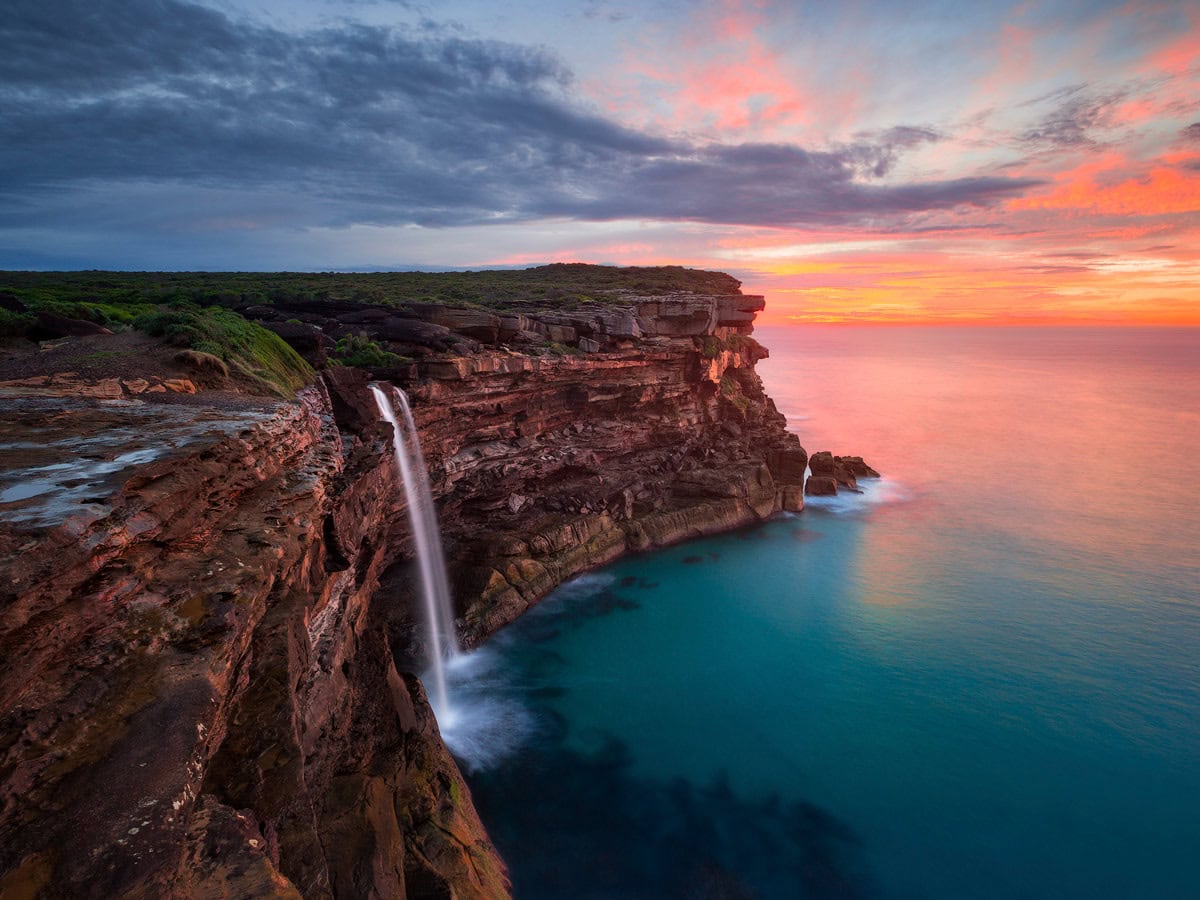 a scenic view of Curracurrong Falls at sunset