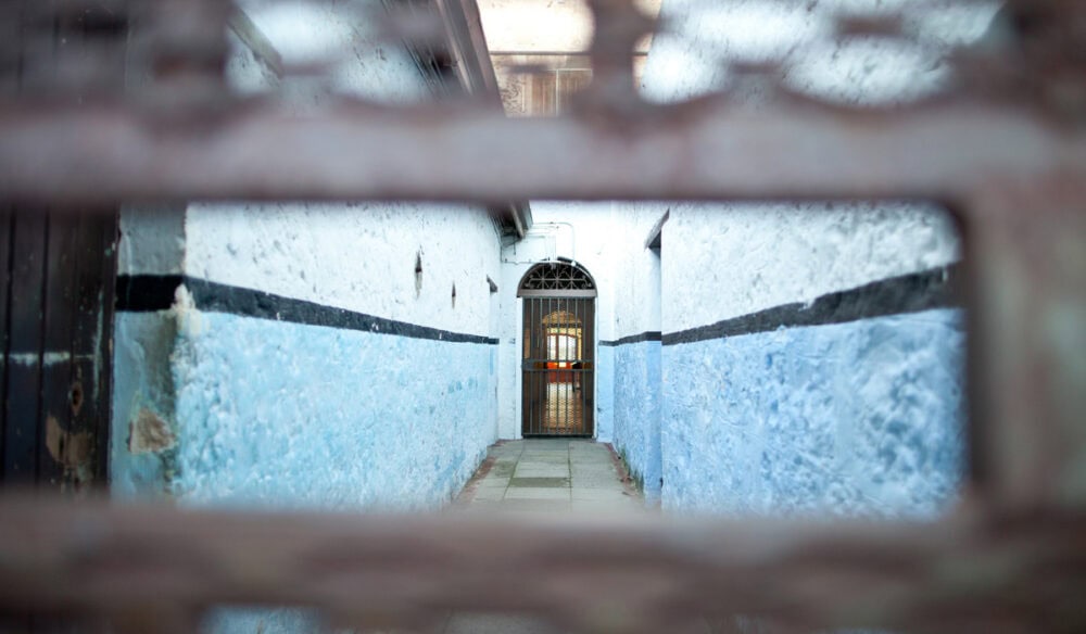 peeking through a small hole in the corridor of Fremantle Prison