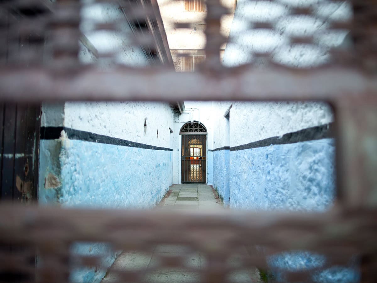 peeking through a small hole in the corridor of Fremantle Prison