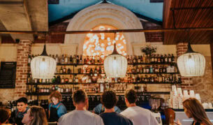 people lining up at the well-lit bar counter of Mr Chapple, Fremantle