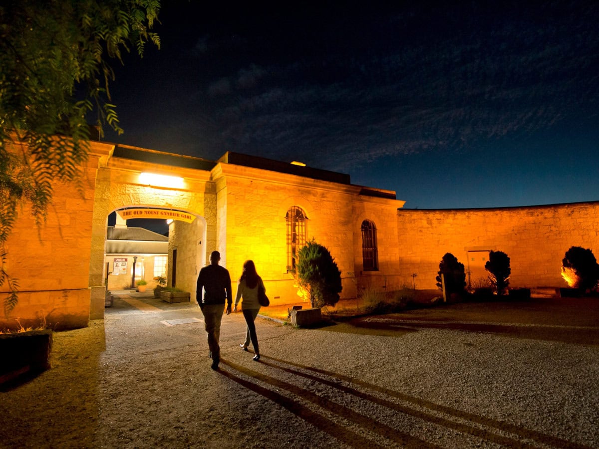 two people entering Old Mount Gambier Gaol at night