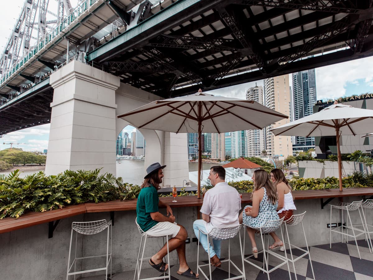 friends dining at Fiume Bar with views of the Story Bridge