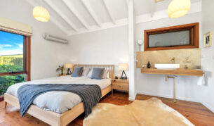 a cosy bedroom at Saddleback Grove, Kiama