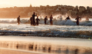 Locals run into the water at Bondi Beach