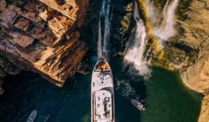 People gather on the deck under King George Falls in the Kimberley on a True North cruiise