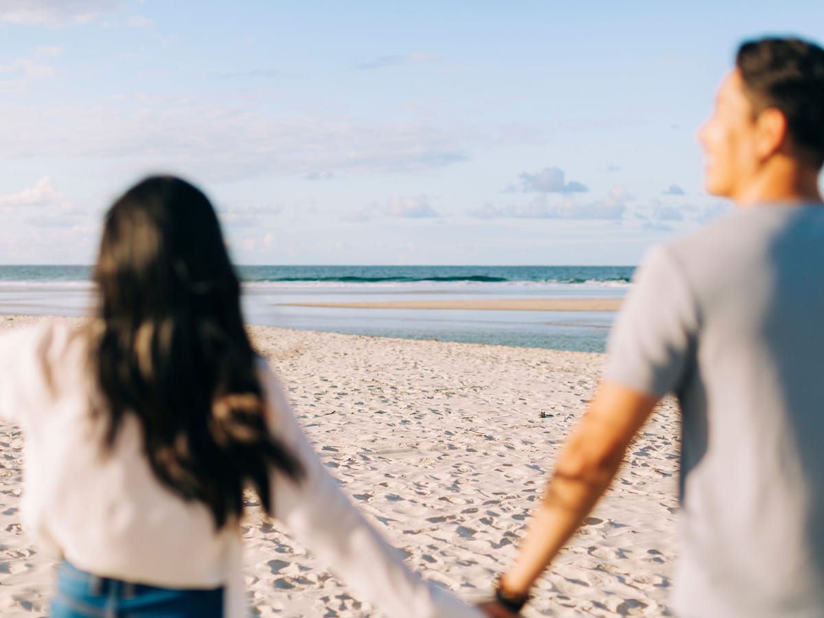 Couple enjoying a visit to North Belongil Beach, Byron Bay.