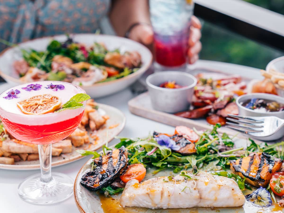 Two women drink cocktails and dine at Oak and Vine Restaurant and Bar in Cairns