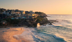 Surfer at Tamarama Beach at sunrise