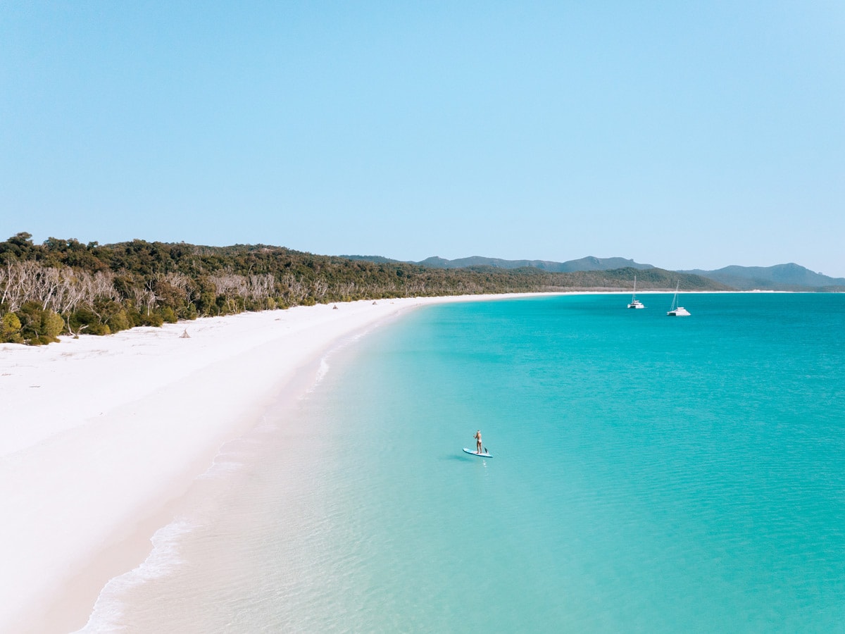 Stand up paddleboarder on Whitehaven beach.