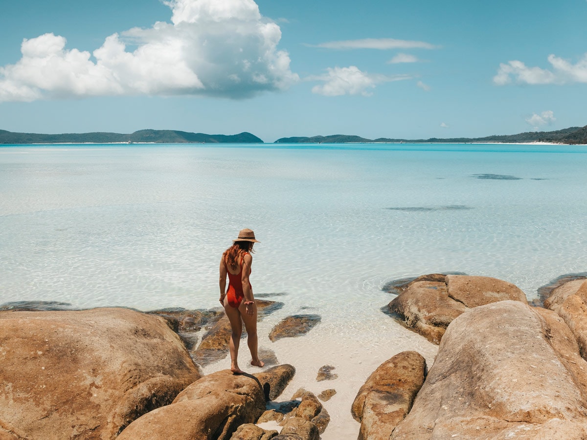 a person standing on a beach rock at Hill Inlet